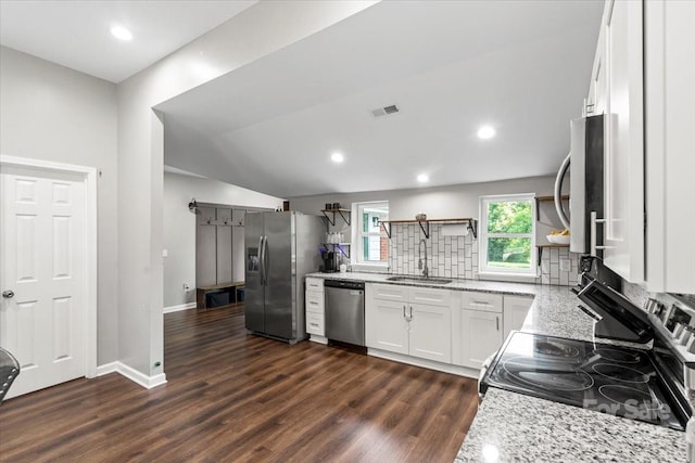 85 Ruritan Park Rd, Stony Point, NC 28678 - kitchen featuring appliances with stainless steel finishes, open shelves, light stone counters, decorative backsplash, and vaulted ceiling