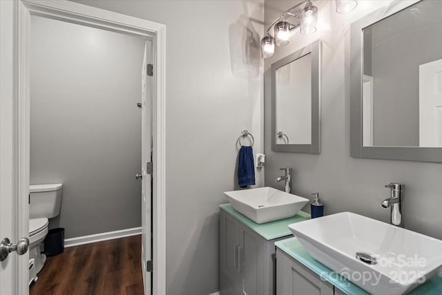 85 Ruritan Park Rd, Stony Point, NC 28678 - bathroom with toilet, wood finished floors, double vanity, and baseboards