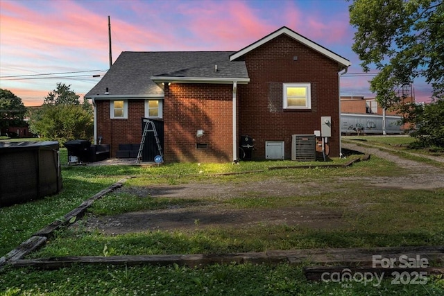 85 Ruritan Park Rd, Stony Point, NC 28678 - back of property with brick siding, a yard, a shingled roof, and central air condition unit