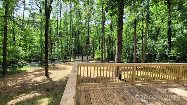 109 Pepper Cir, Mooresville, NC 28117 - wooden terrace featuring a fenced backyard, an outdoor structure, and a wooded view