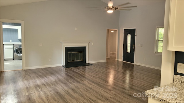 109 Pepper Cir, Mooresville, NC 28117 - unfurnished living room featuring washer / dryer, ceiling fan, a glass covered fireplace, high vaulted ceiling, and wood finished floors