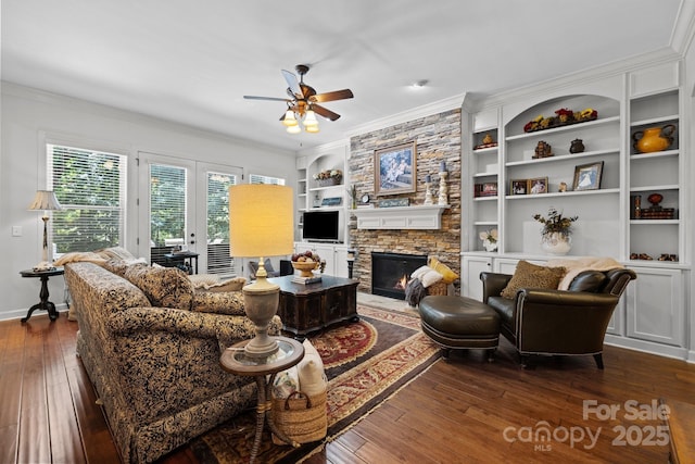 3009 Botetourt Ct, Weddington, NC 28104 - living room with dark wood-style flooring, crown molding, ceiling fan, built in shelves, and a stone fireplace