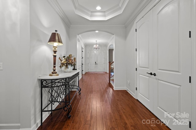 3009 Botetourt Ct, Weddington, NC 28104 - hall featuring arched walkways, dark wood finished floors, ornamental molding, and a raised ceiling