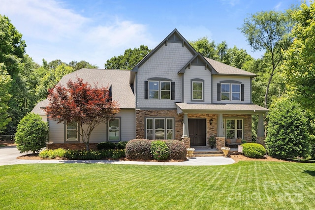 3009 Botetourt Ct, Weddington, NC 28104 - craftsman inspired home with stone siding, a front yard, a porch, and a shingled roof