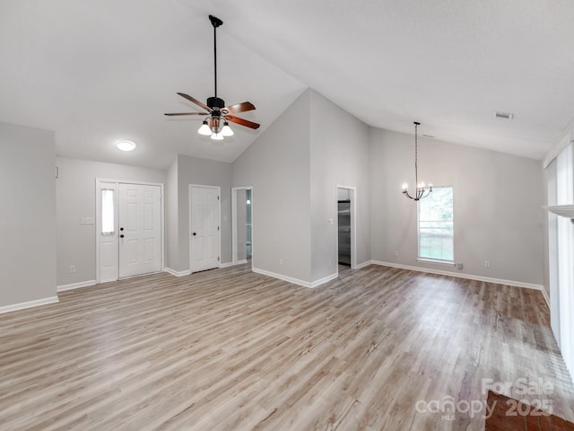 10736 Spruce Mountain Rd, Charlotte, NC 28214 - unfurnished living room with a chandelier, light wood-type flooring, a ceiling fan, high vaulted ceiling, and baseboards