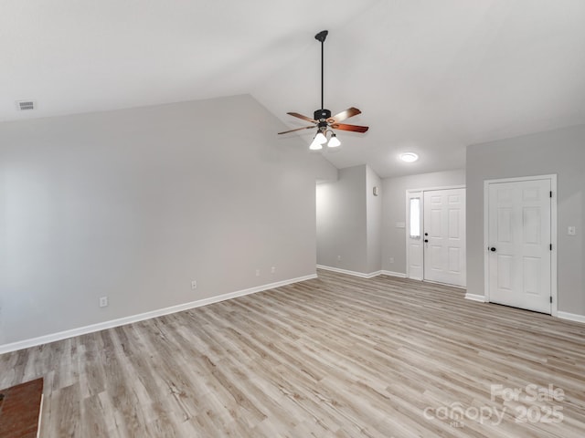 10736 Spruce Mountain Rd, Charlotte, NC 28214 - unfurnished living room featuring ceiling fan, lofted ceiling, baseboards, and light wood-type flooring