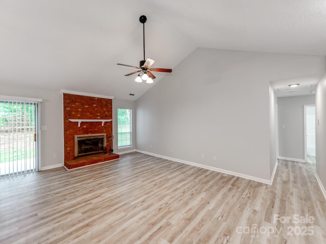 10736 Spruce Mountain Rd, Charlotte, NC 28214 - unfurnished living room featuring a ceiling fan, light wood-style flooring, a fireplace, baseboards, and high vaulted ceiling