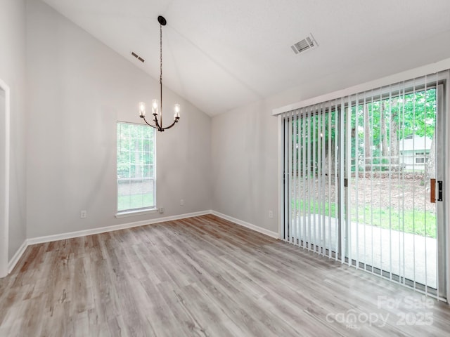 10736 Spruce Mountain Rd, Charlotte, NC 28214 - spare room featuring plenty of natural light, a chandelier, baseboards, vaulted ceiling, and wood finished floors