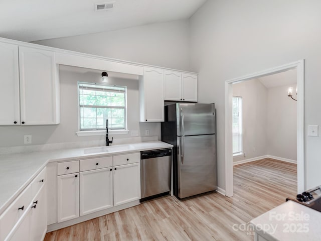 10736 Spruce Mountain Rd, Charlotte, NC 28214 - kitchen with stainless steel appliances, a sink, white cabinetry, light wood-style floors, and light countertops