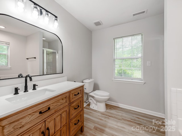 10736 Spruce Mountain Rd, Charlotte, NC 28214 - full bath featuring toilet, vanity, wood finished floors, a shower with door, and baseboards