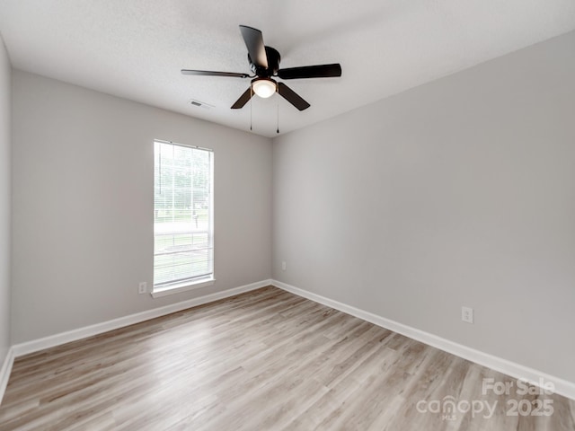 10736 Spruce Mountain Rd, Charlotte, NC 28214 - spare room featuring light wood-type flooring, ceiling fan, and baseboards