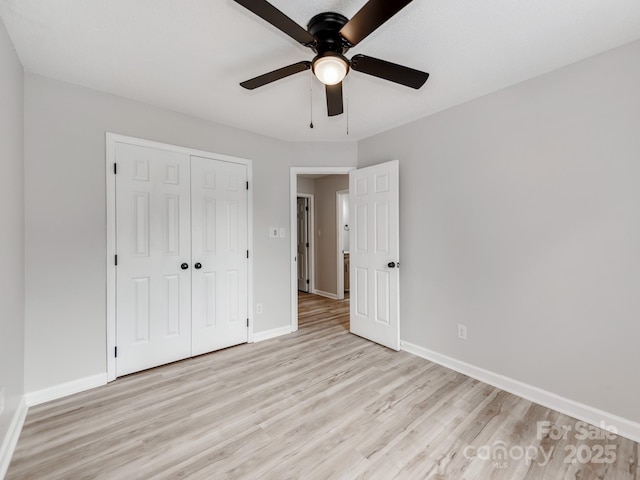 10736 Spruce Mountain Rd, Charlotte, NC 28214 - unfurnished bedroom with light wood-type flooring, baseboards, a closet, and ceiling fan