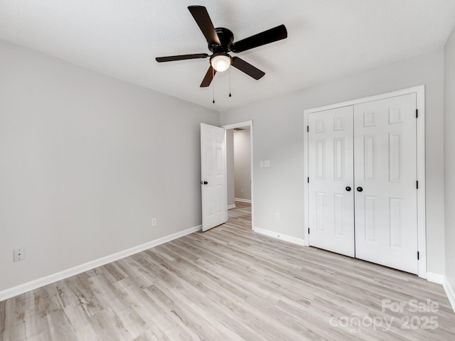 10736 Spruce Mountain Rd, Charlotte, NC 28214 - unfurnished bedroom featuring light wood-type flooring, baseboards, a closet, and ceiling fan