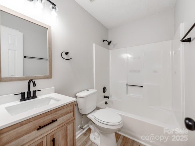10736 Spruce Mountain Rd, Charlotte, NC 28214 - full bath with wood finished floors, vanity, toilet, bathtub / shower combination, and a textured ceiling