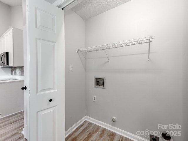 10736 Spruce Mountain Rd, Charlotte, NC 28214 - laundry room featuring light wood-type flooring, hookup for a washing machine, and baseboards