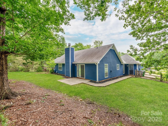 10736 Spruce Mountain Rd, Charlotte, NC 28214 - back of property with a chimney, a patio area, and roof with shingles
