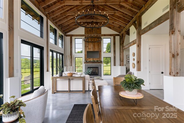 30 Greene Ln, Fletcher, NC 28732 - dining room with high vaulted ceiling, wooden ceiling, healthy amount of natural light, a glass covered fireplace, and a chandelier