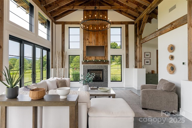 30 Greene Ln, Fletcher, NC 28732 - living room featuring high vaulted ceiling, wood ceiling with exposed beams, a glass covered fireplace, a chandelier, and baseboards