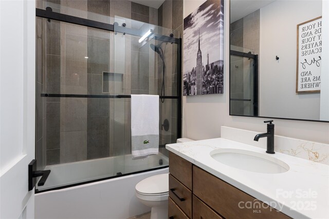 30 Greene Ln, Fletcher, NC 28732 - full bathroom featuring toilet, vanity, and shower / bath combination with glass door