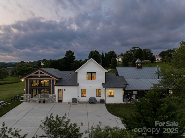 30 Greene Ln, Fletcher, NC 28732 - rear view of house with central air condition unit, a lawn, and roof with shingles