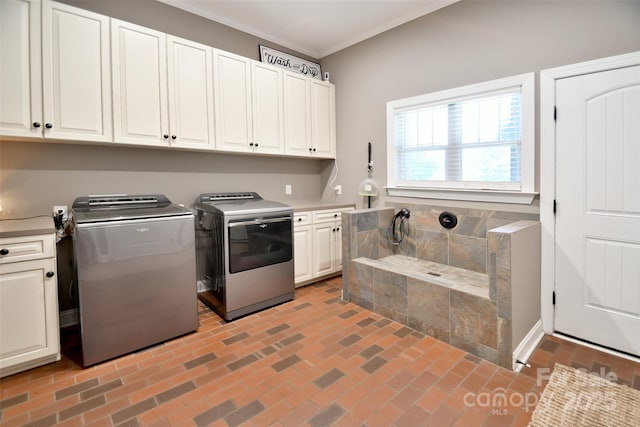 114 Wingard Rd, Concord, NC 28025 - laundry area with cabinet space, brick patterned flooring, ornamental molding, and washer and clothes dryer