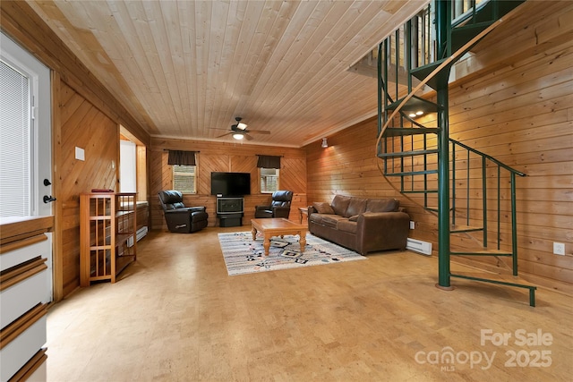 261 Franks Cove Rd, Brevard, NC 28712 - living room with wood walls, ceiling fan, a baseboard radiator, wood ceiling, and stairs