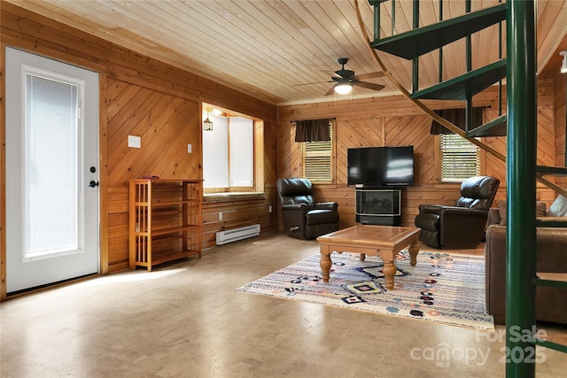261 Franks Cove Rd, Brevard, NC 28712 - living area featuring wood walls, baseboard heating, ceiling fan, finished concrete floors, and healthy amount of natural light