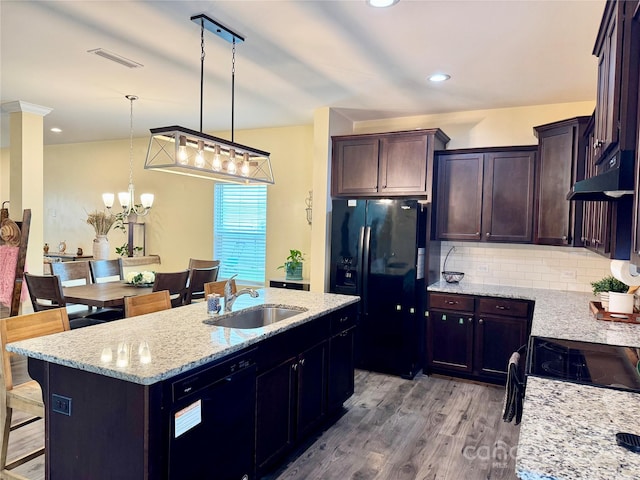 750 Fraternity Row, Kannapolis, NC 28081 - kitchen with black appliances, a sink, a kitchen breakfast bar, light wood-type flooring, and light stone countertops