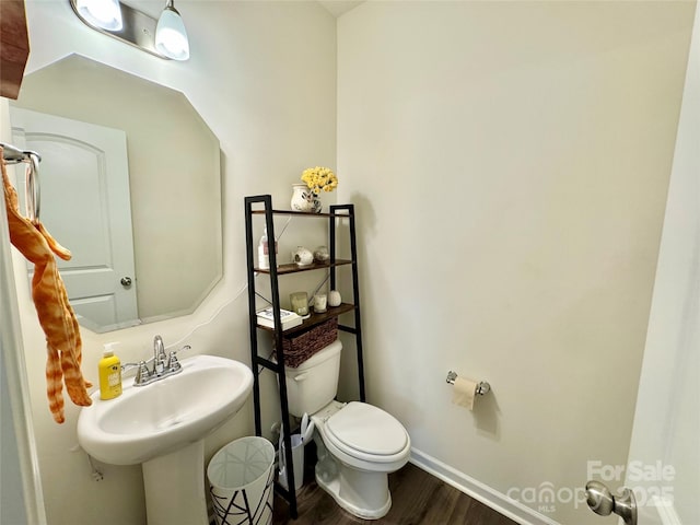 750 Fraternity Row, Kannapolis, NC 28081 - half bath featuring toilet, wood finished floors, baseboards, and a sink
