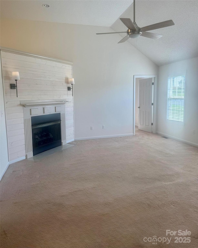 1743 Silver Stream Dr, Rock Hill, SC 29730 - unfurnished living room with ceiling fan, vaulted ceiling, a fireplace with flush hearth, baseboards, and carpet flooring