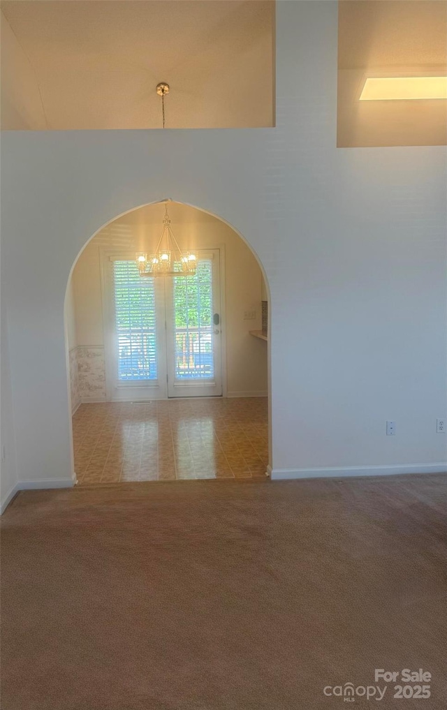 1743 Silver Stream Dr, Rock Hill, SC 29730 - carpeted spare room with a chandelier, arched walkways, and baseboards