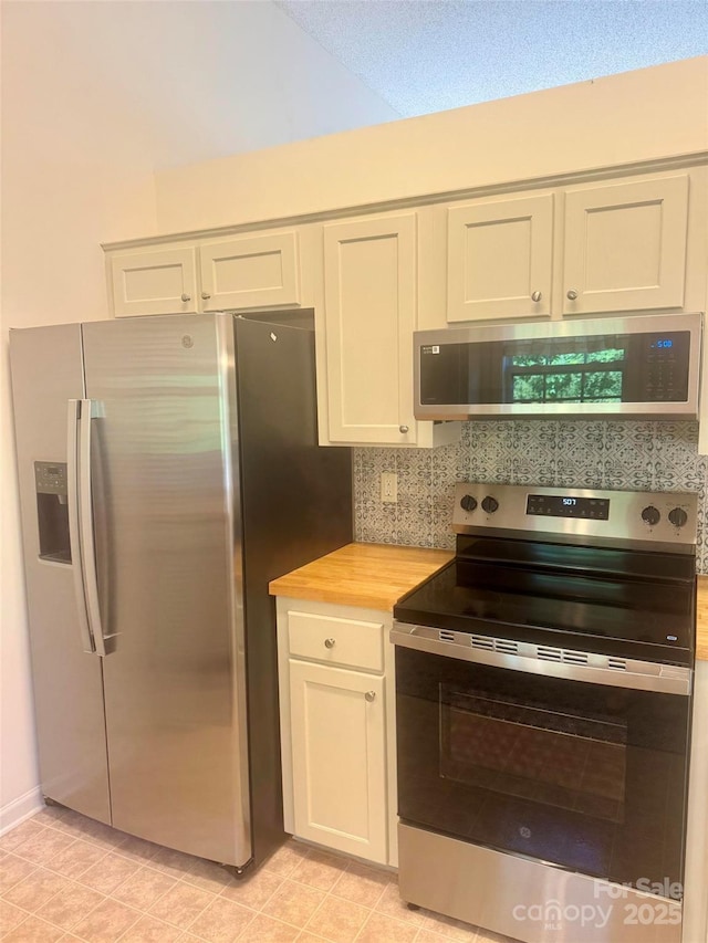 1743 Silver Stream Dr, Rock Hill, SC 29730 - kitchen with stainless steel appliances, wooden counters, tasteful backsplash, and white cabinets
