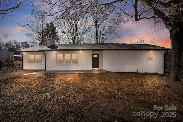 5520 Chestnut Dr, Hickory, NC 28602 - view of front of home featuring a chimney and brick siding