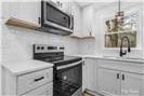 5520 Chestnut Dr, Hickory, NC 28602 - kitchen featuring stainless steel appliances, light countertops, and a sink