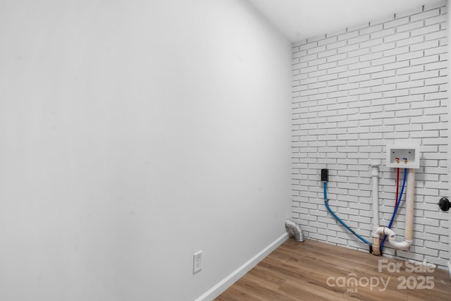 5520 Chestnut Dr, Hickory, NC 28602 - laundry room with hookup for a washing machine, wood finished floors, baseboards, and brick wall