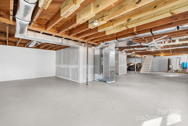 5520 Chestnut Dr, Hickory, NC 28602 - unfinished below grade area with electric water heater, stairs, and heating unit