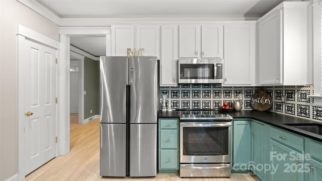 6129 Caseys Side Way, Fort Mill, SC 29708 - kitchen with stainless steel appliances, dark countertops, light wood-style floors, backsplash, and white cabinets