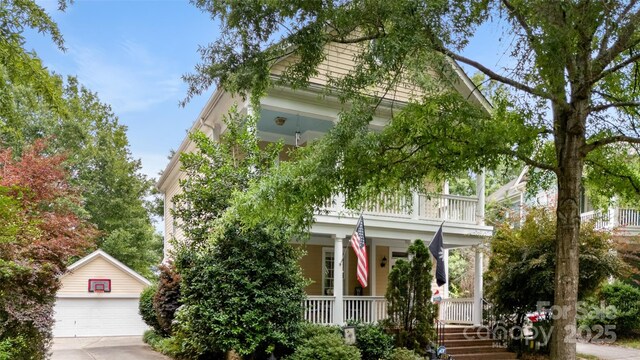 6129 Caseys Side Way, Fort Mill, SC 29708 - view of property hidden behind natural elements featuring a porch, an outdoor structure, a balcony, and a detached garage