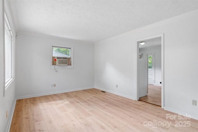 1310 Caldwell St, Greensboro, NC 27406 - spare room featuring a textured ceiling, light wood finished floors, ornamental molding, baseboards, and cooling unit