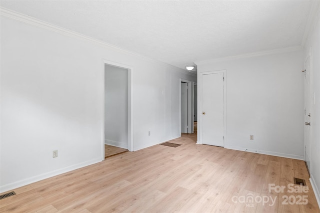 1310 Caldwell St, Greensboro, NC 27406 - empty room featuring crown molding, light wood-type flooring, and baseboards