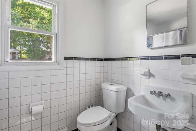 1310 Caldwell St, Greensboro, NC 27406 - full bathroom with toilet, tile walls, a sink, and wainscoting