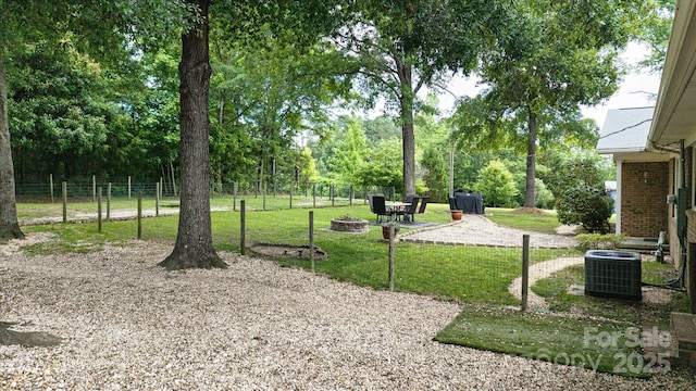 2618 Pineview Dr, Lancaster, SC 29720 - view of yard with cooling unit, an outdoor fire pit, and view of wooded area