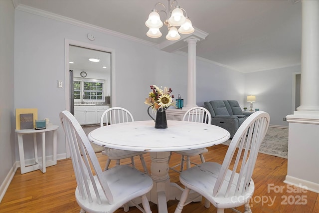 2618 Pineview Dr, Lancaster, SC 29720 - dining room featuring decorative columns, light wood-type flooring, crown molding, baseboards, and a chandelier