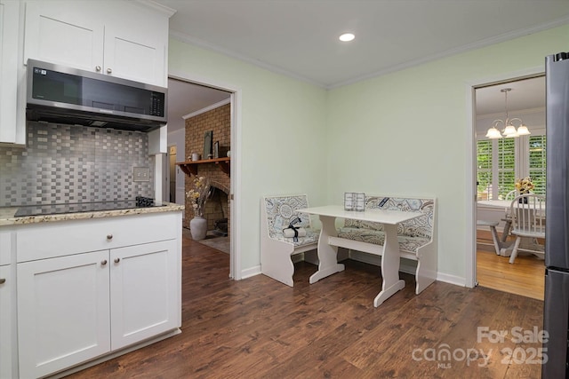 2618 Pineview Dr, Lancaster, SC 29720 - dining space featuring crown molding, dark wood finished floors, a chandelier, baseboards, and recessed lighting