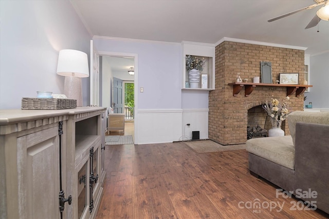 2618 Pineview Dr, Lancaster, SC 29720 - living room with a ceiling fan, wood finished floors, crown molding, wainscoting, and a brick fireplace