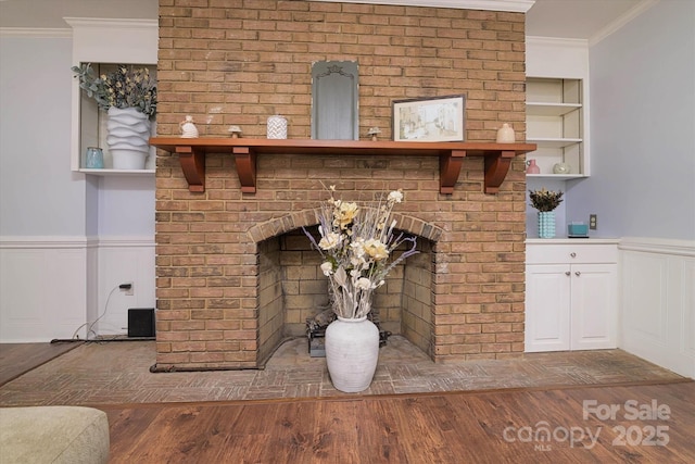 2618 Pineview Dr, Lancaster, SC 29720 - detailed view of a brick fireplace, wood finished floors, a wainscoted wall, crown molding, and built in features