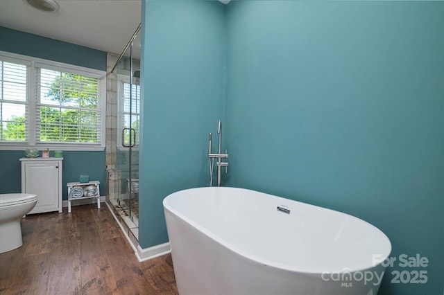 2618 Pineview Dr, Lancaster, SC 29720 - bathroom with a soaking tub, wood finished floors, a stall shower, toilet, and baseboards