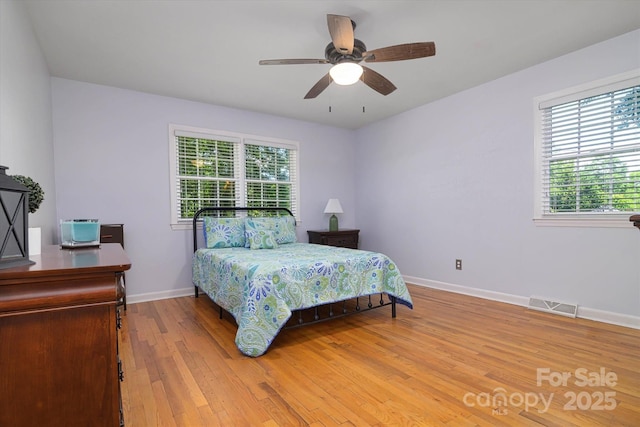 2618 Pineview Dr, Lancaster, SC 29720 - bedroom with multiple windows, light wood-type flooring, baseboards, and ceiling fan