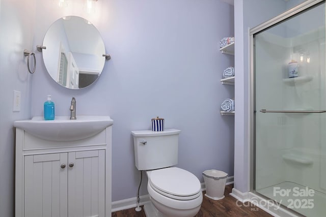 2618 Pineview Dr, Lancaster, SC 29720 - full bathroom with wood finished floors, a stall shower, vanity, toilet, and baseboards