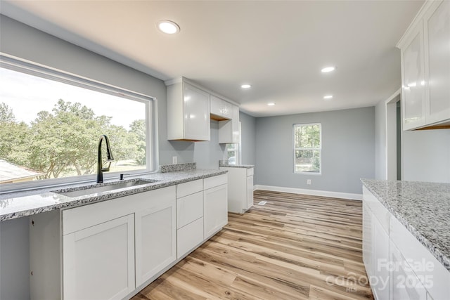1224 Martin Rd, Hickory Grove, SC 29717 - kitchen with a sink, recessed lighting, light wood finished floors, light stone countertops, and white cabinetry